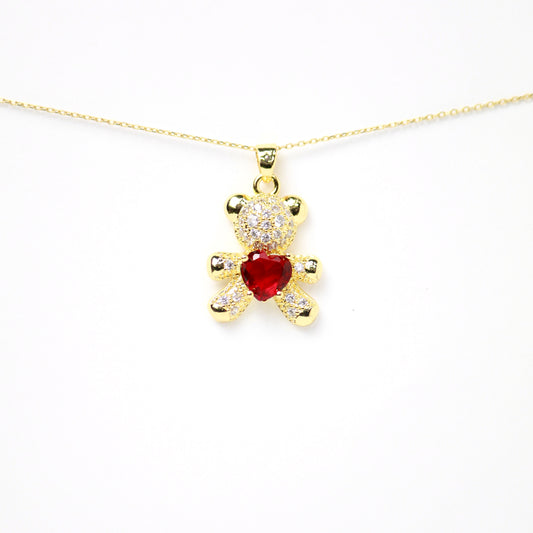 Dije de osito con incrustaciones de diamantes y piedra rojo rubí central en forma de corazón, Oro laminado
