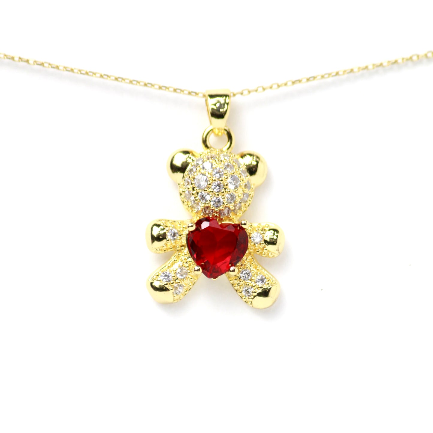 Dije de osito con incrustaciones de diamantes y piedra rojo rubí central en forma de corazón, Oro laminado