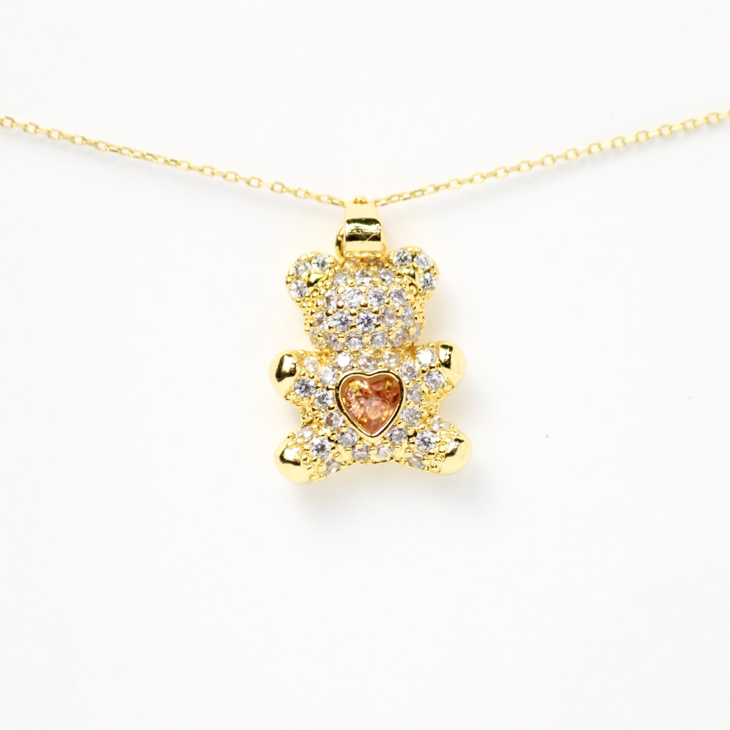 Osito con diamantes incrustados y diamante flotante en el centro de corazón rosa, Oro laminado